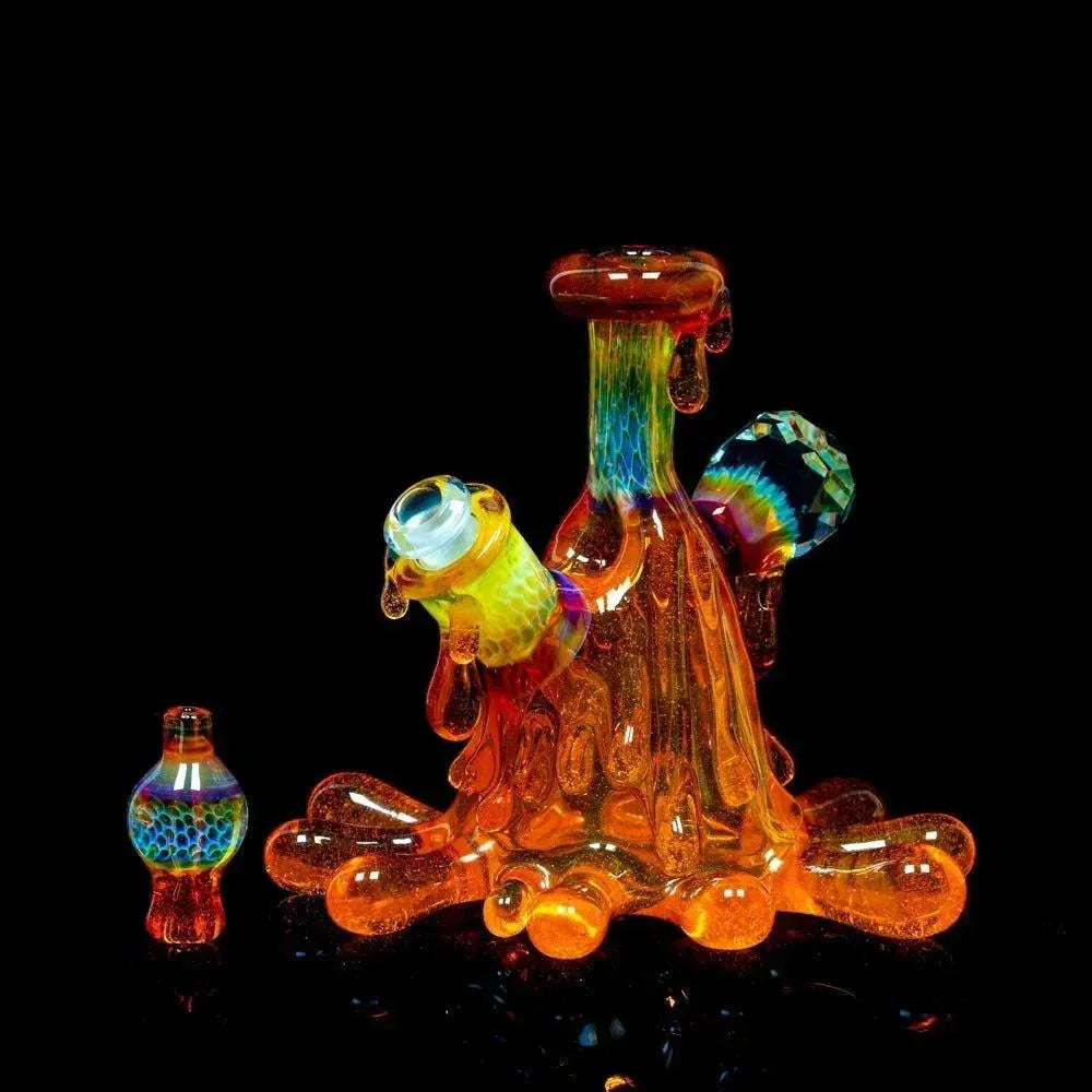 Colorful art glass water pipe with dripping effect and matching cap on black background