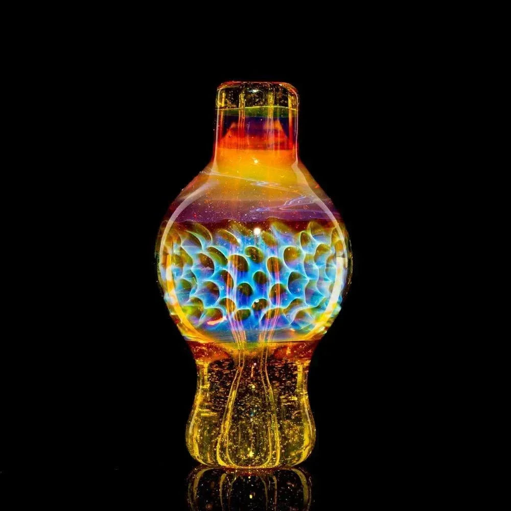 Colorful hand-blown glass carb cap with intricate patterns on a black background