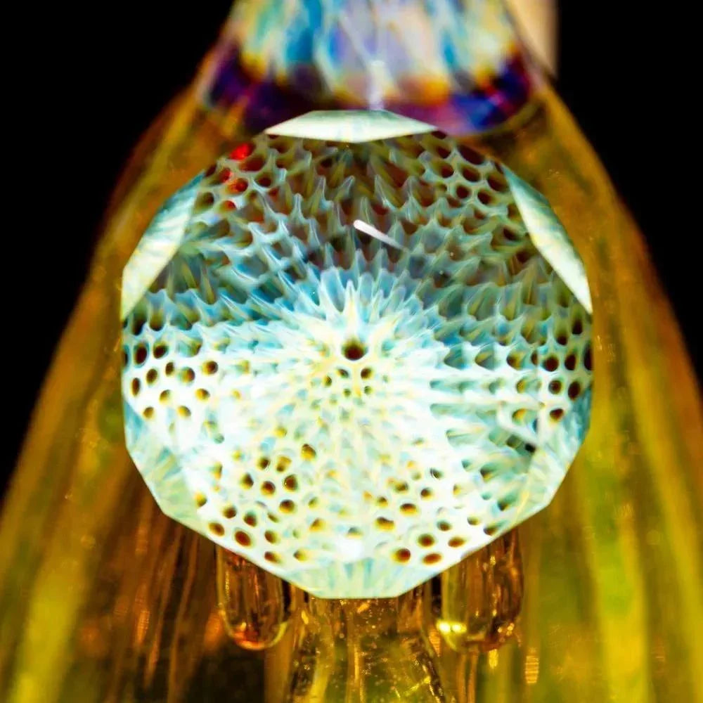 Close-up of intricate, multicolor glass art detail on a handcrafted glass water pipe.