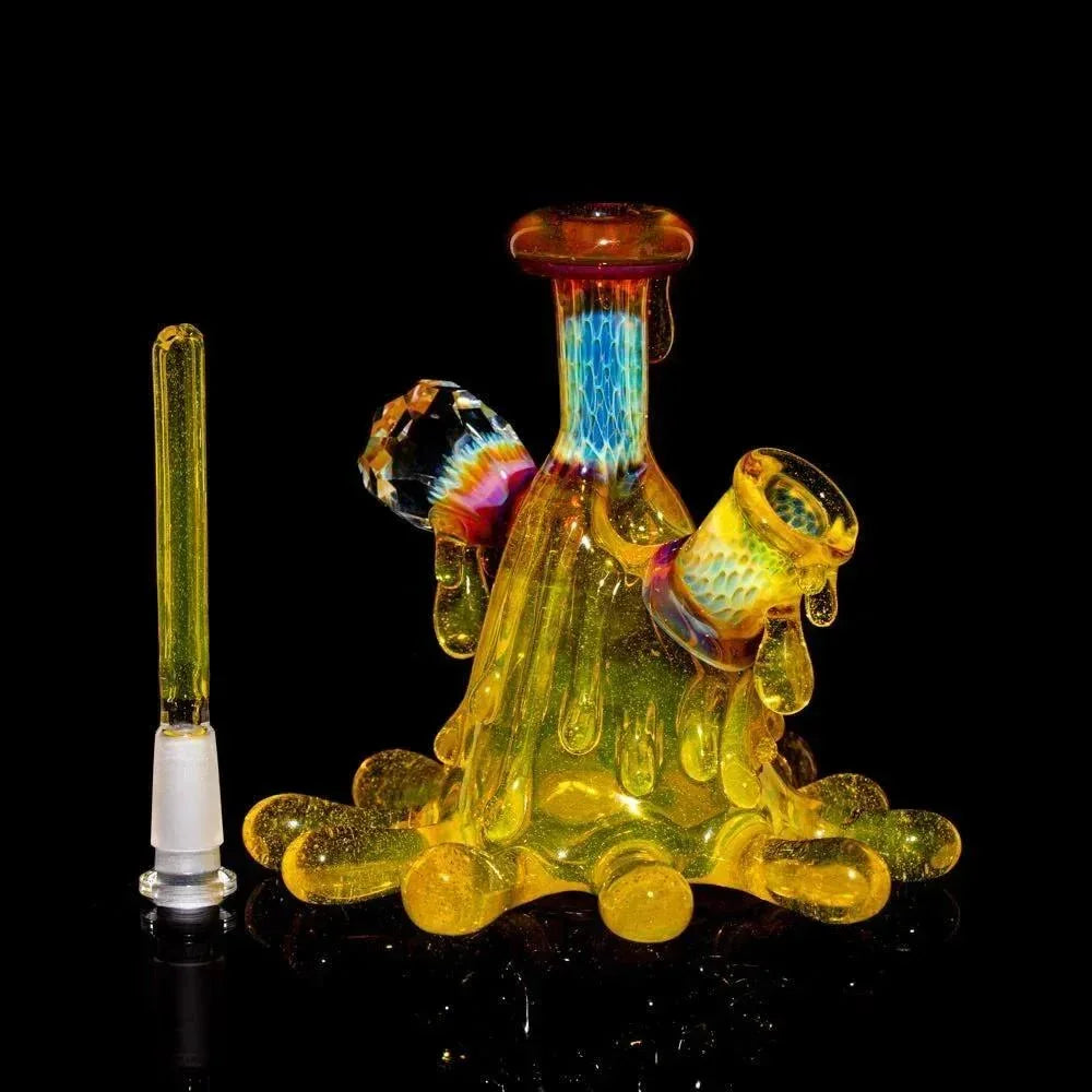 Colorful glass water pipe with matching cap, unique melting design on black background.