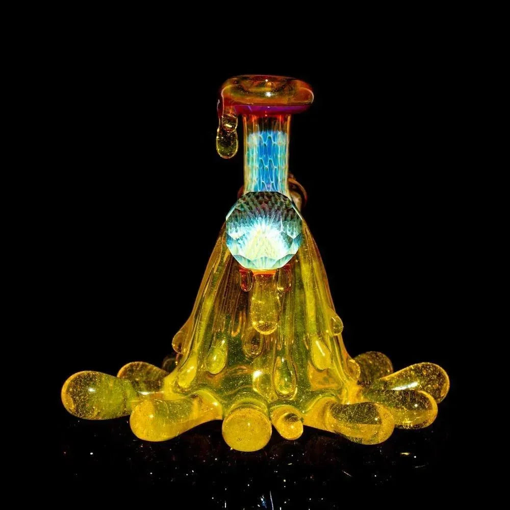 Hand-blown yellow glass art pipe with droplet design and iridescent details on black background
