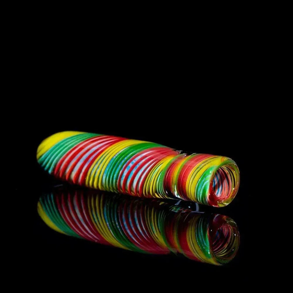 Vibrant rainbow striped glass pipe with spiral design, reflecting on black surface