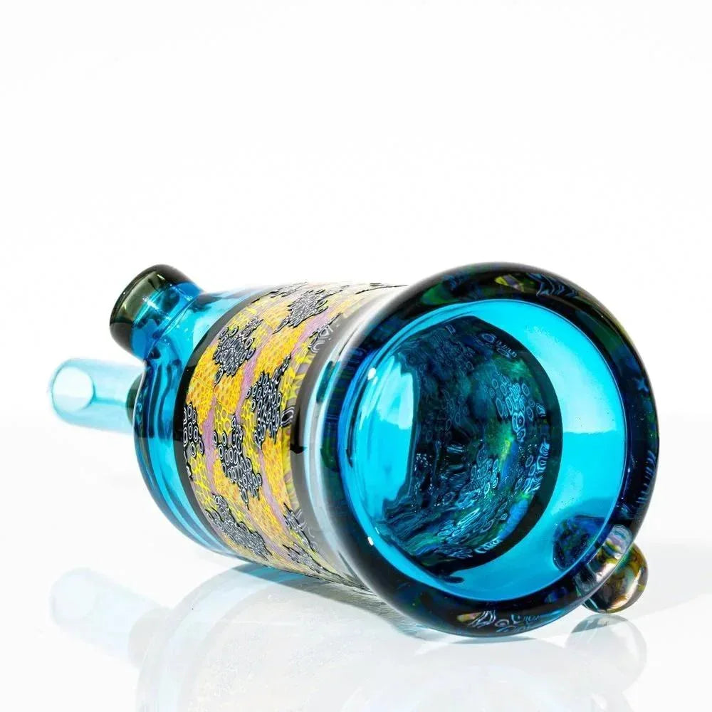 Handblown blue glass water pipe with yellow murrine pattern on white background