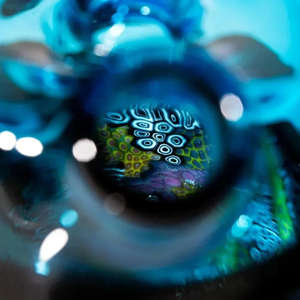 Close-up of blue murrine glass rig with intricate colorful patterns and abstract designs