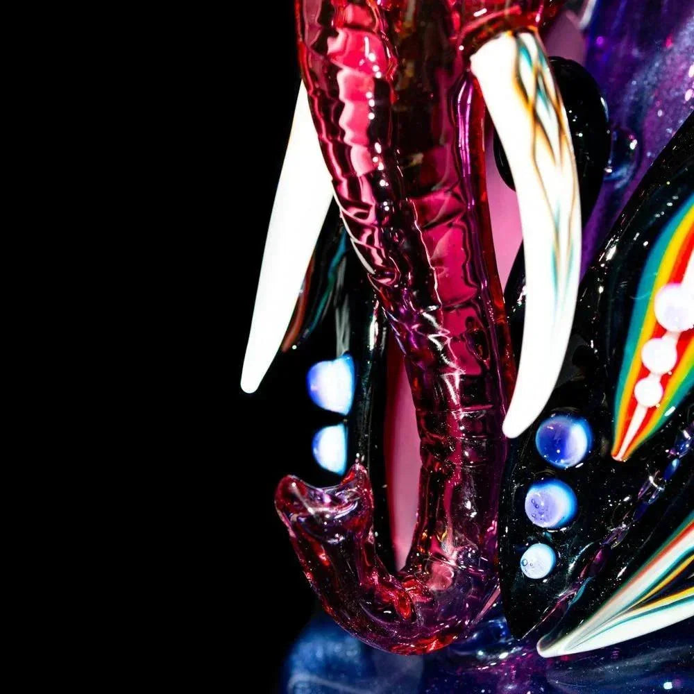 Colorful glass elephant recycler with tusks and intricate artistic details, close-up view.