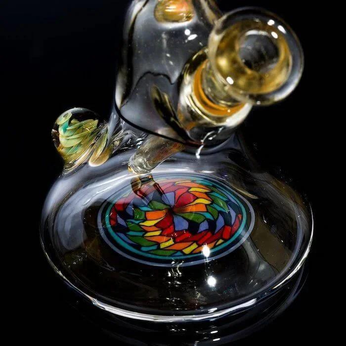 Colorful stained-glass bong with intricate swirls, heady glass art for smoke shop collection