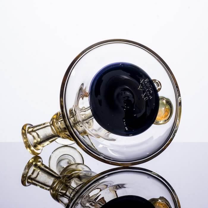 Handcrafted glass pipe with blue bowl and amber accents, ideal for heady glass collectors