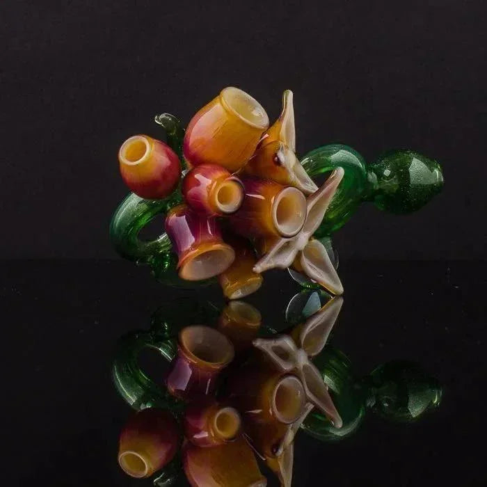 Colorful heady glass pipe with floral design, vibrant amber and green hues, reflective surface