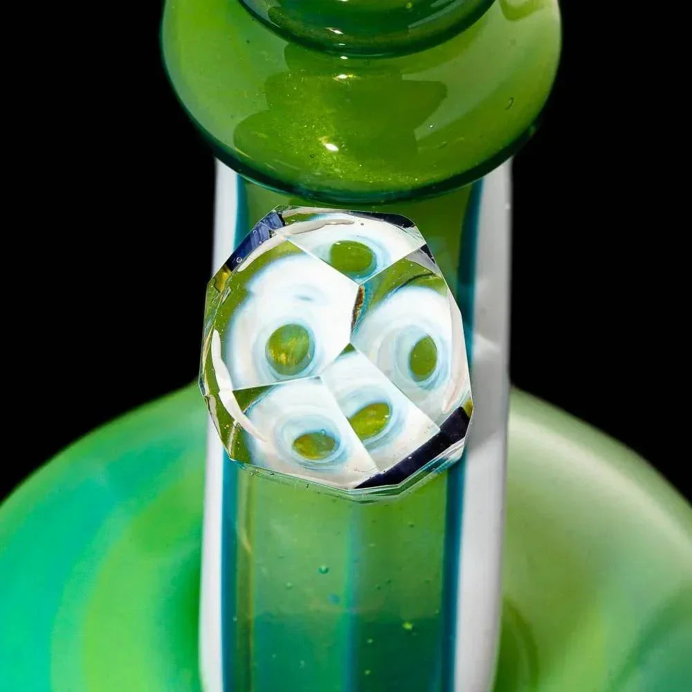 Close-up of green glass water pipe with faceted marble accent detail on the neck