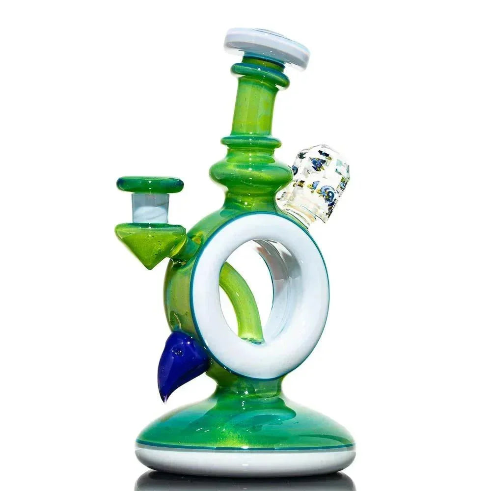 Green and white glass water pipe with artistic accents and unique circular design on white background.