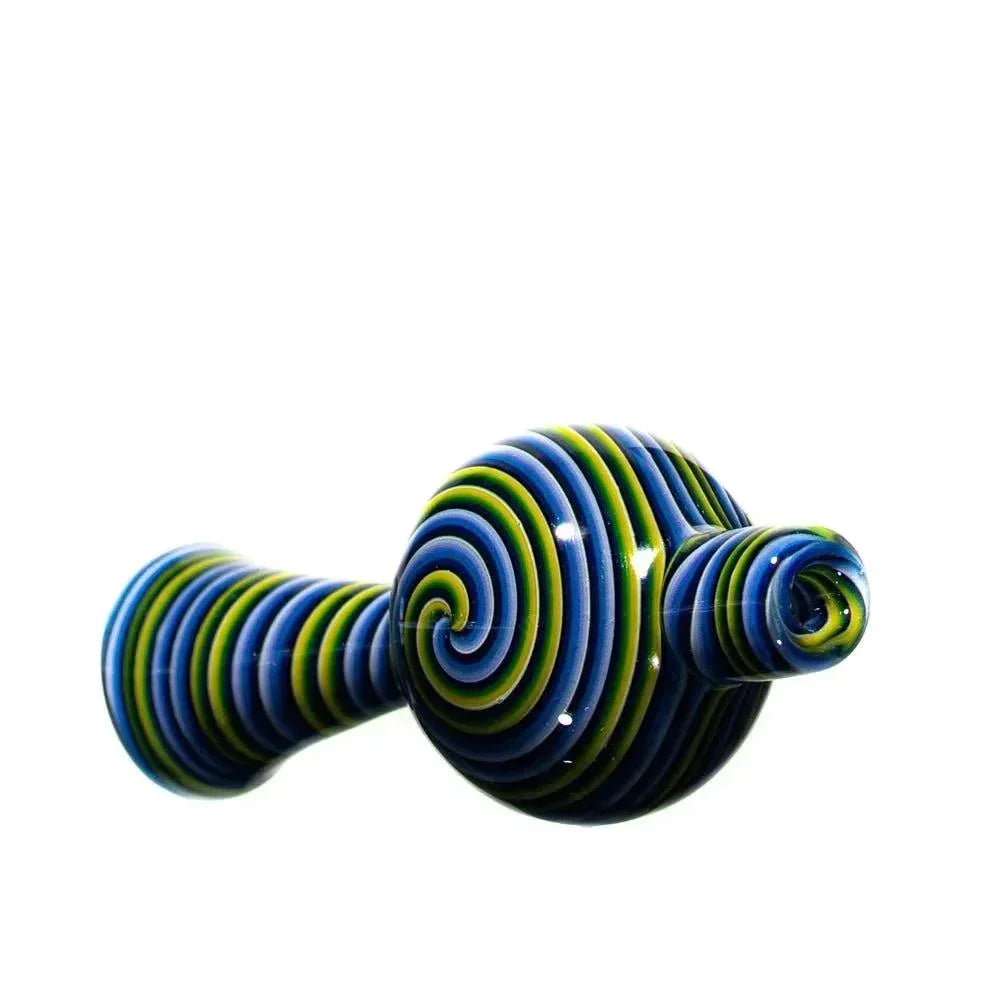 Colorful glass bubble cap with blue, green, and yellow swirl design on white background