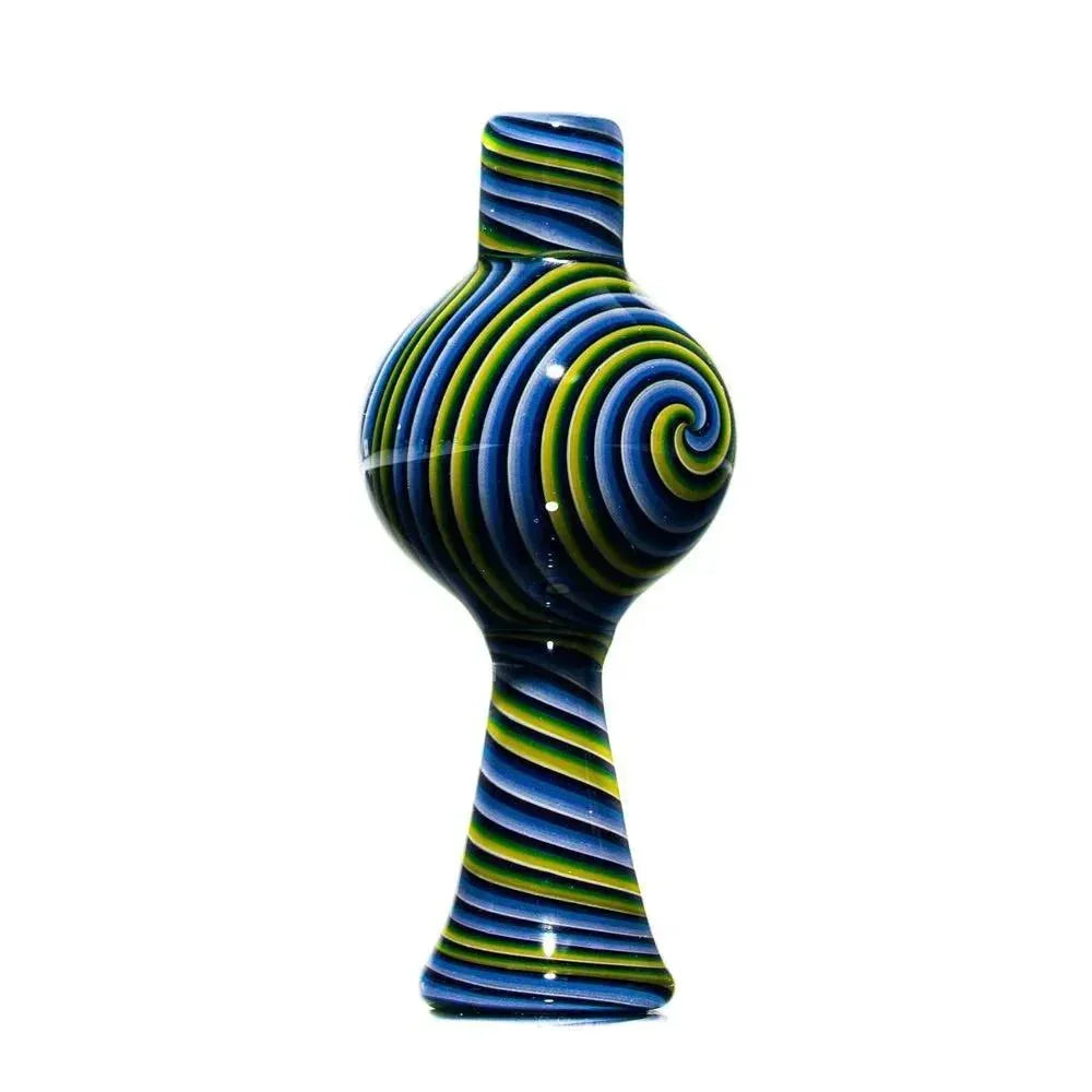 Colorful glass bubble cap with blue, green, and yellow spiral pattern on white background