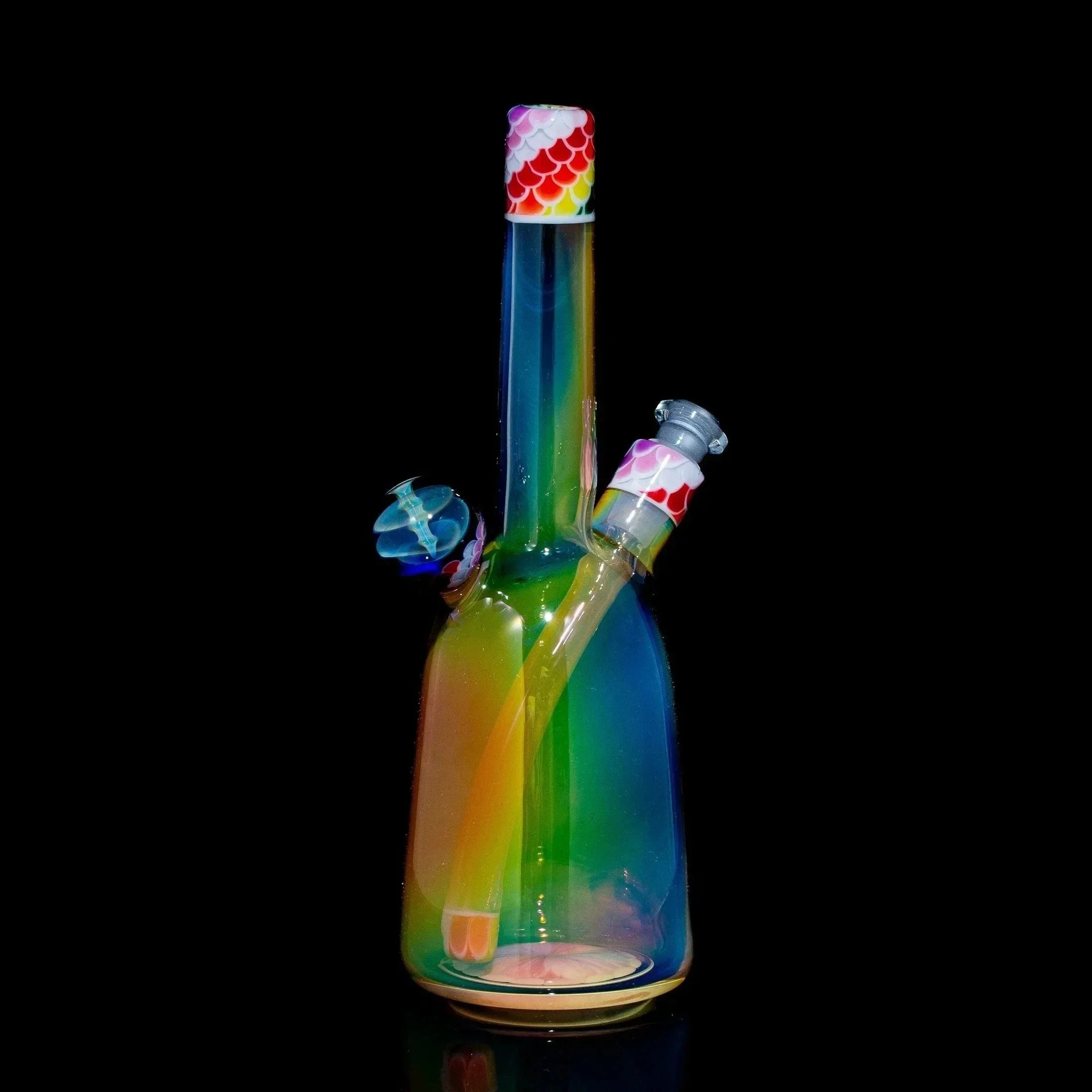 Rainbow glass water pipe with dot-stack accents and matching sherlock cap, black background