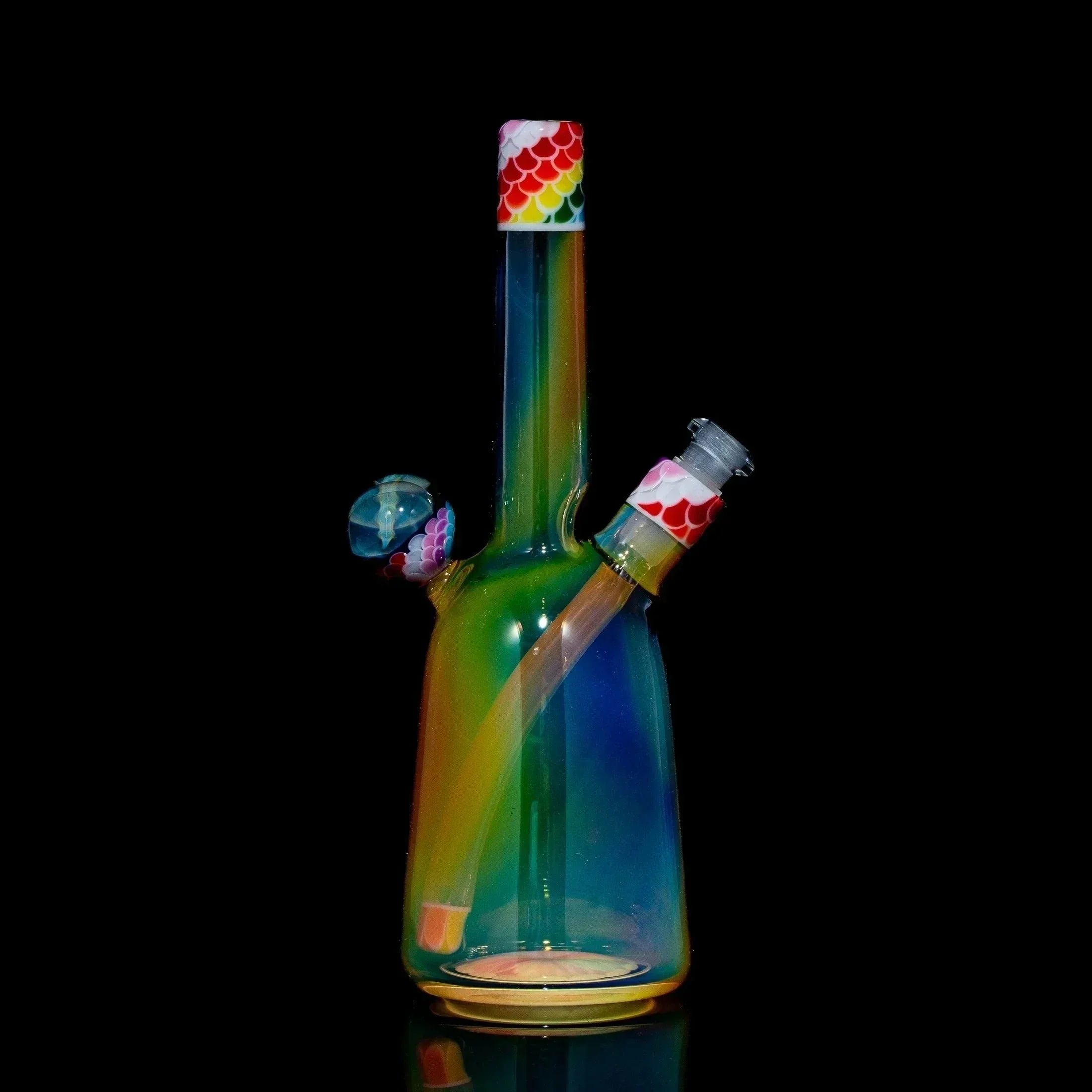 Rainbow dotstack glass rig with matching sherlock cap and colored accents on a black background.