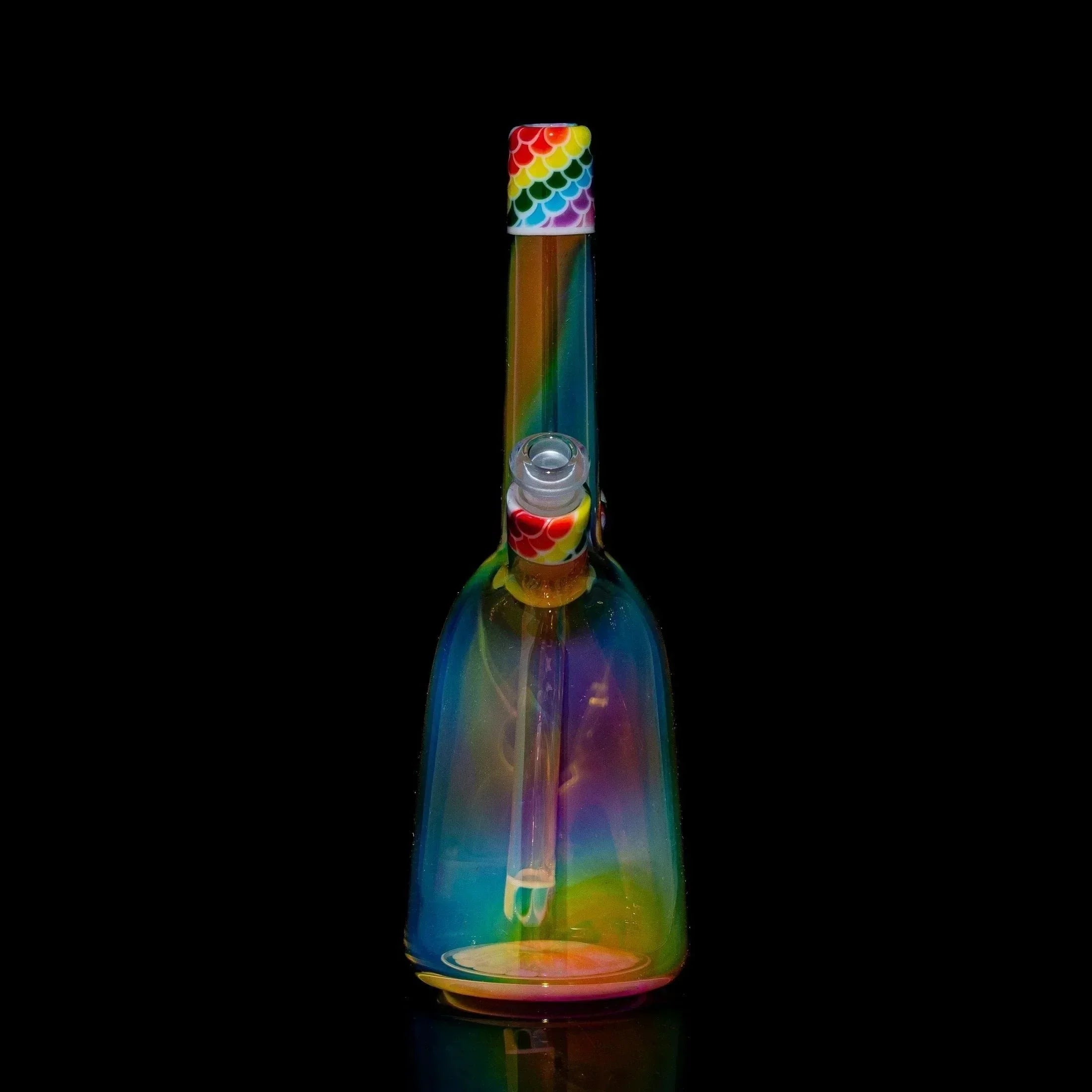 Colorful rainbow glass rig with patterned mouthpiece on black background