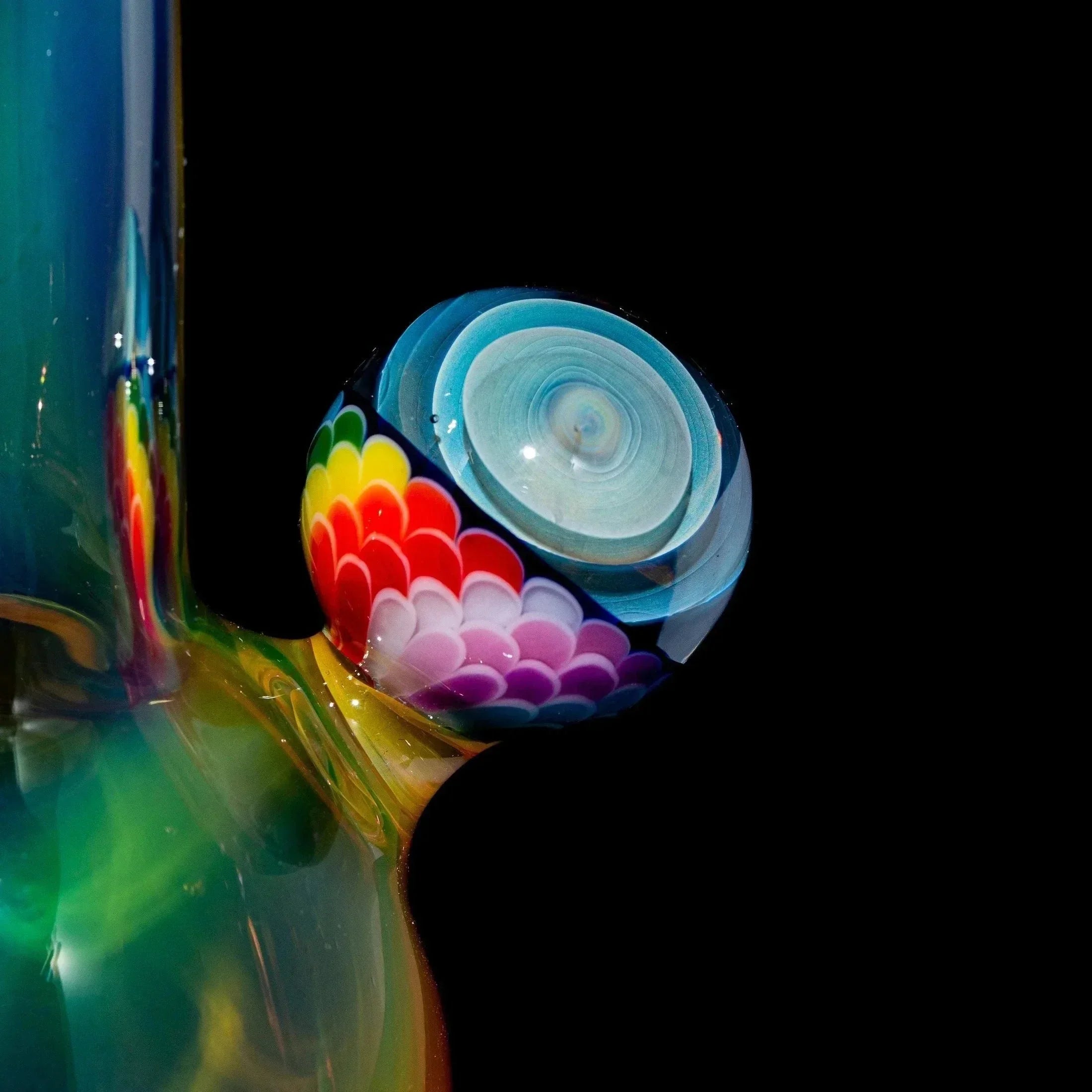 Colorful glass rig detail with rainbow dot patterns and intricate artisan glasswork