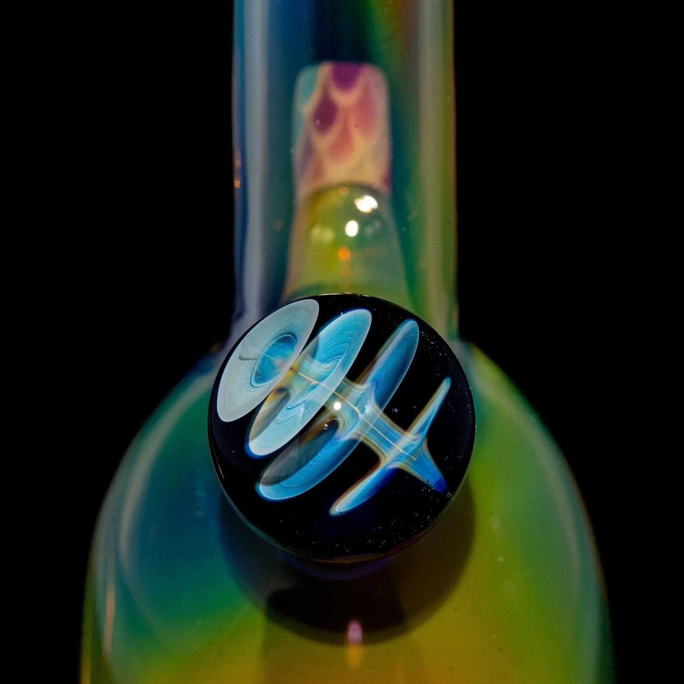 Colorful glass rig with a detailed blue opal carb cap, rainbow iridescent finish