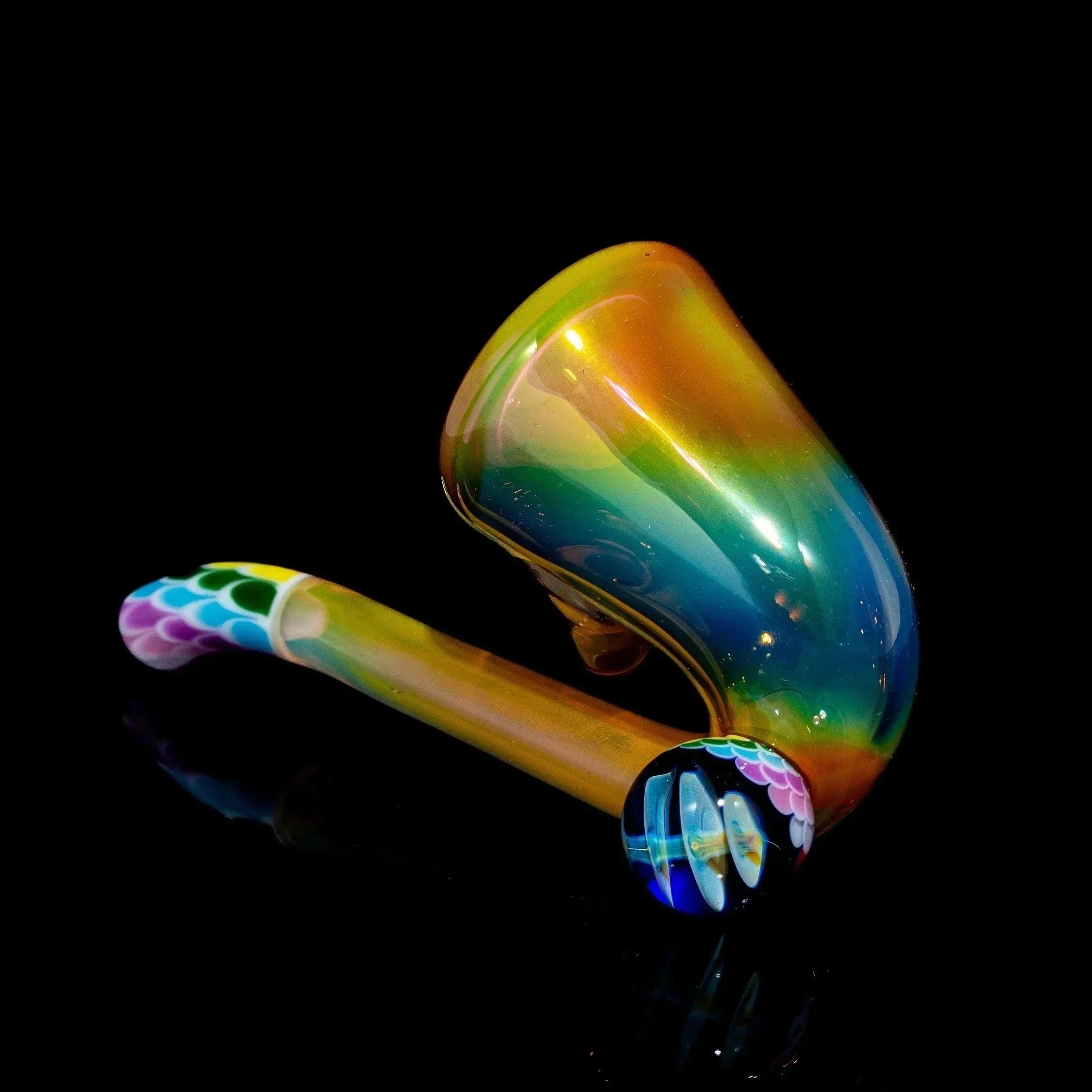Rainbow glass pipe with colorful dot patterns and matching glass cap on black background