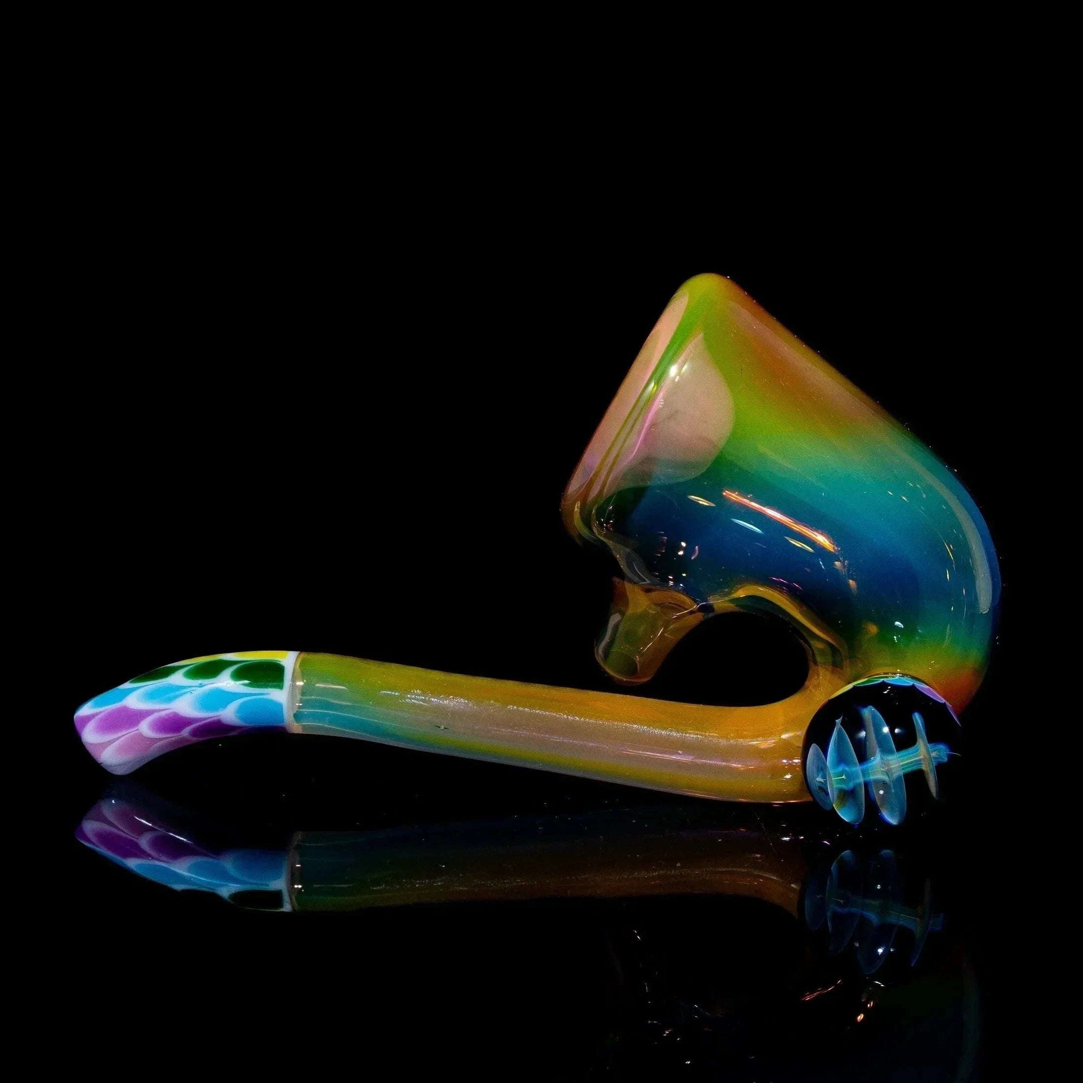 Colorful glass sherlock pipe with rainbow and dot pattern on a black background
