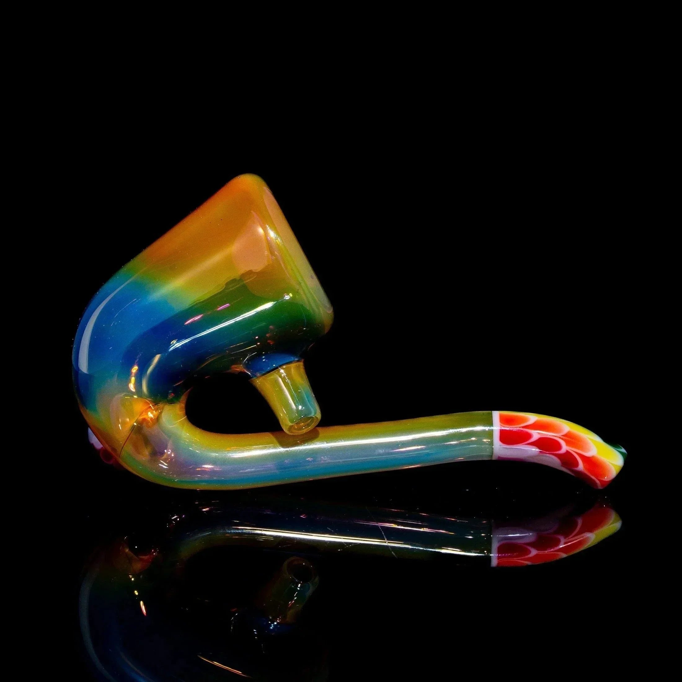 Hand-blown glass sherlock pipe with rainbow colors and dot pattern, on black background.