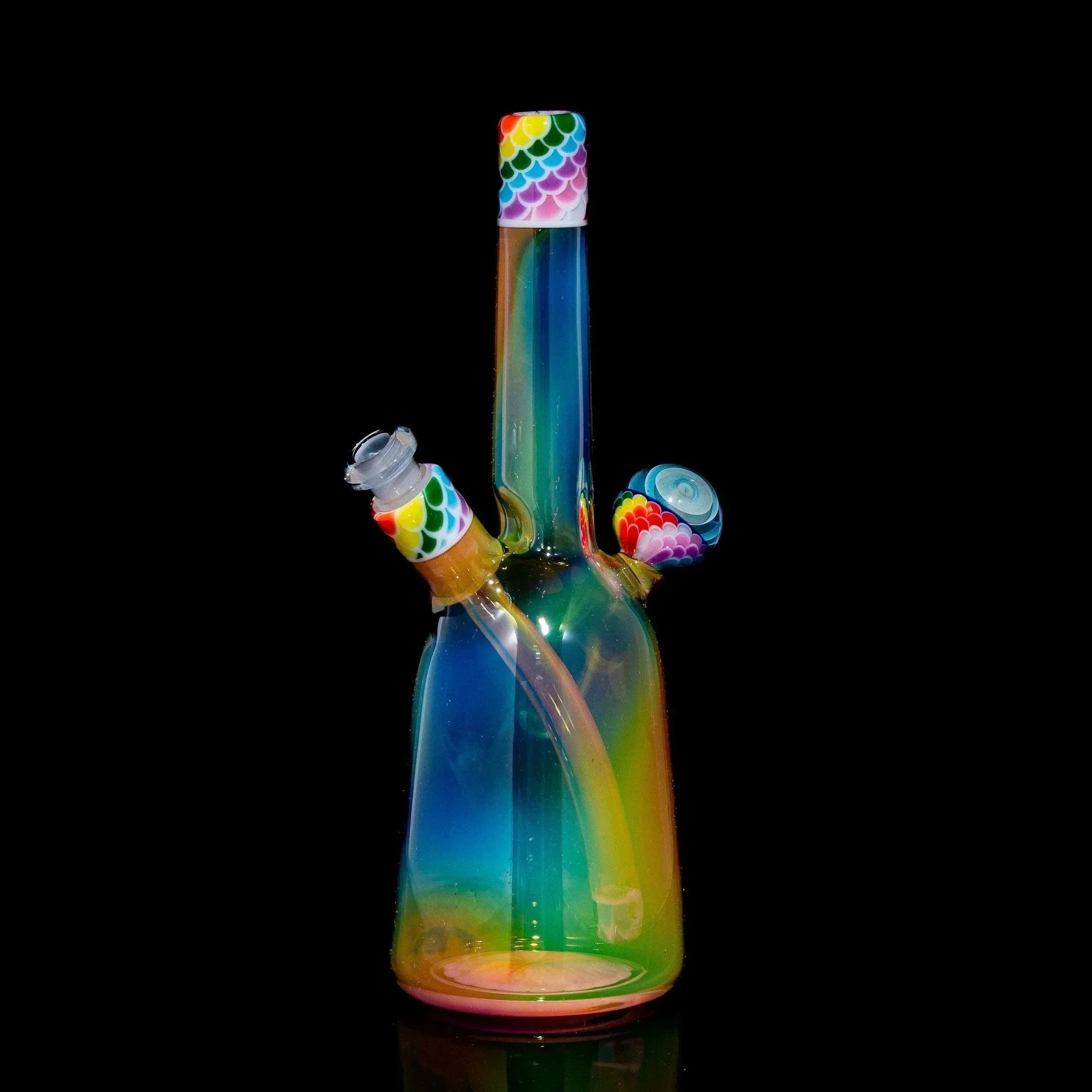 Colorful glass dab rig with rainbow dot stack pattern and matching accessories