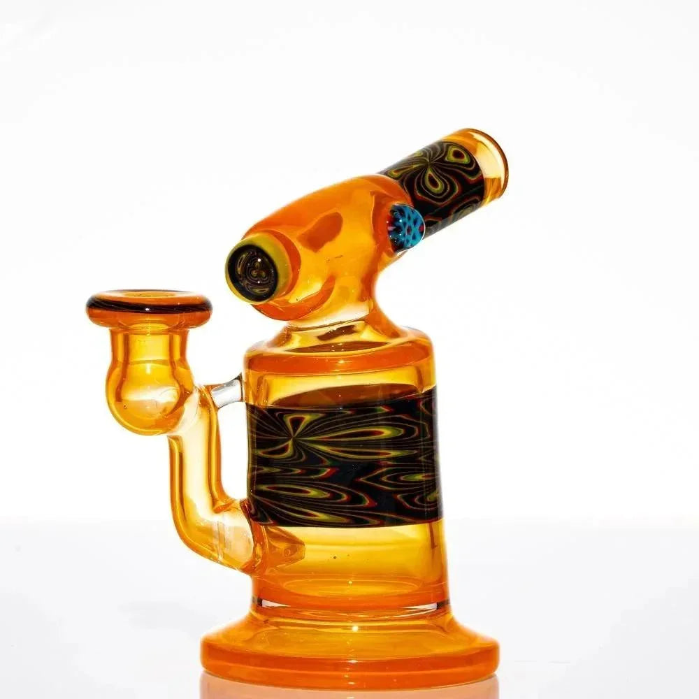 Mini orange glass water pipe with black and multicolored swirl details on white background
