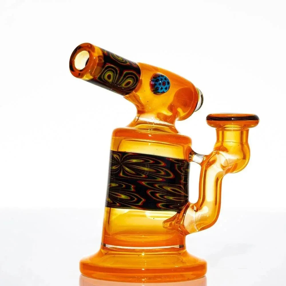 Orange glass mini torch-style water pipe with intricate black and colorful patterned accents.