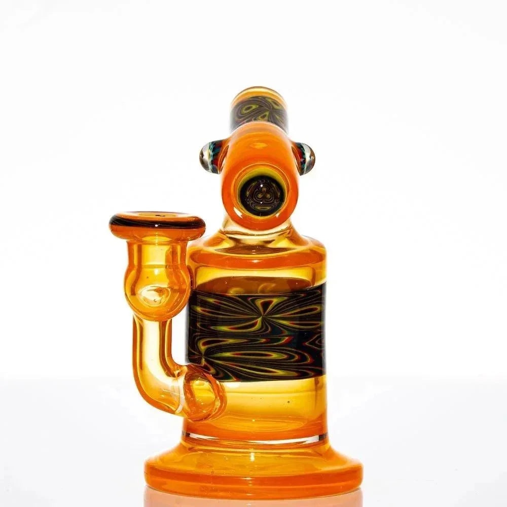 Orange glass mini water pipe with intricate swirl pattern and clear accents on white background