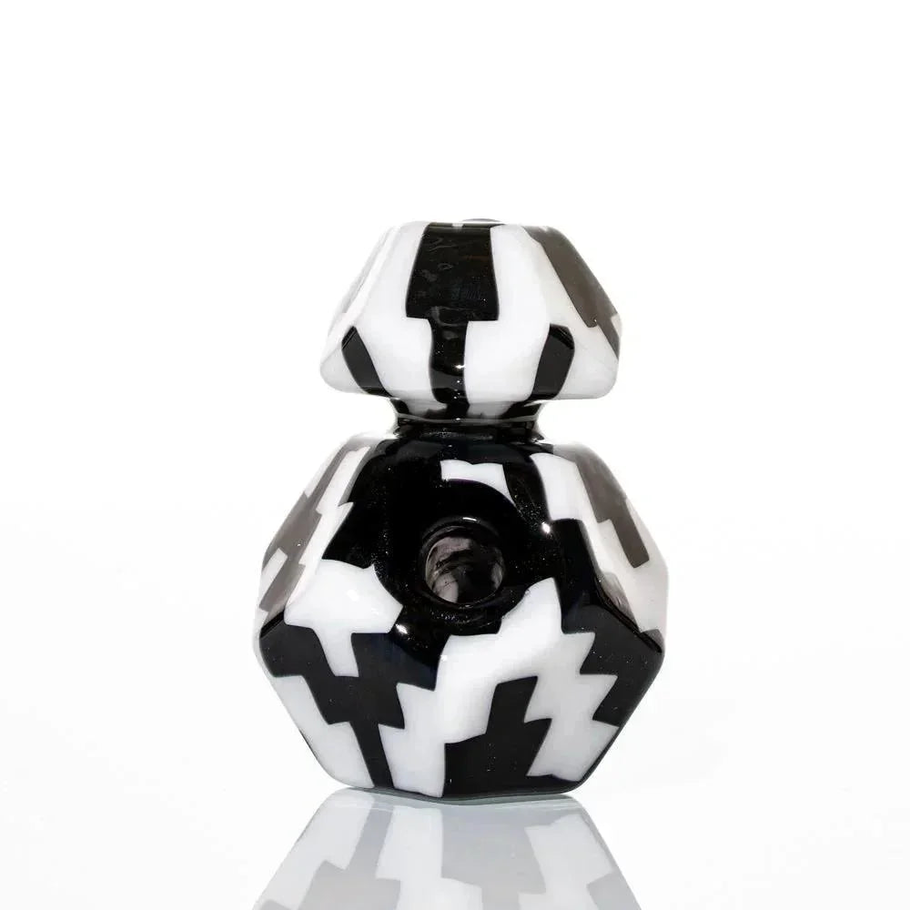 Black and white geometric glass pipe with bold zigzag pattern on white background
