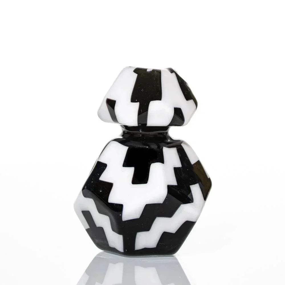 Geometric black and white glass art piece with bold zigzag pattern on white background