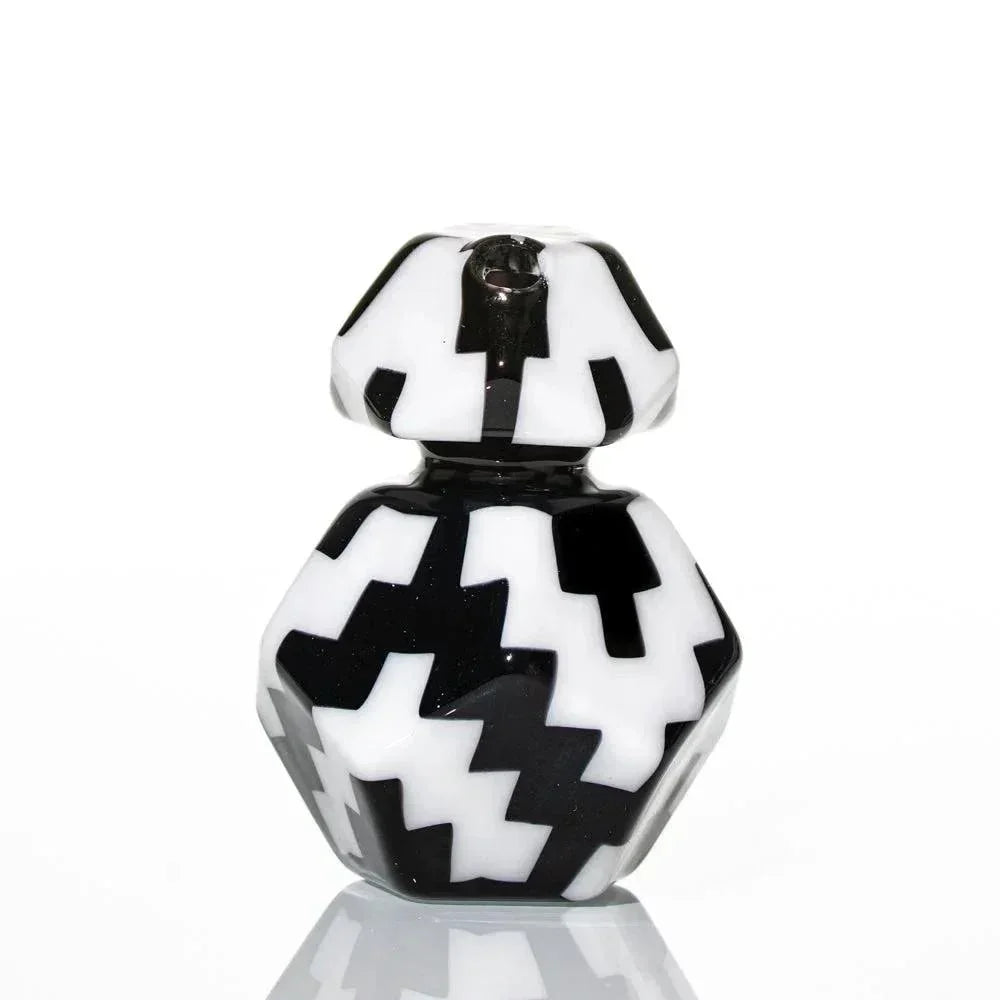 Geometric black and white glass pipe with bold zigzag pattern on white background