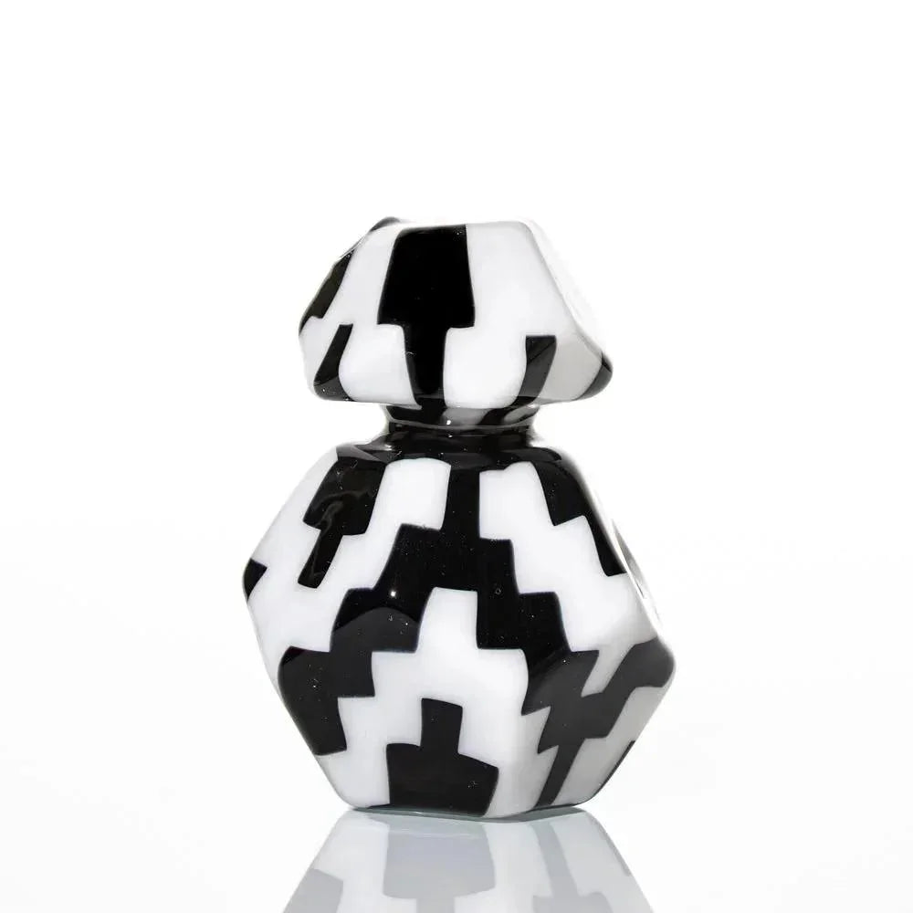 Black and white geometric glass art piece with zigzag pattern on white background