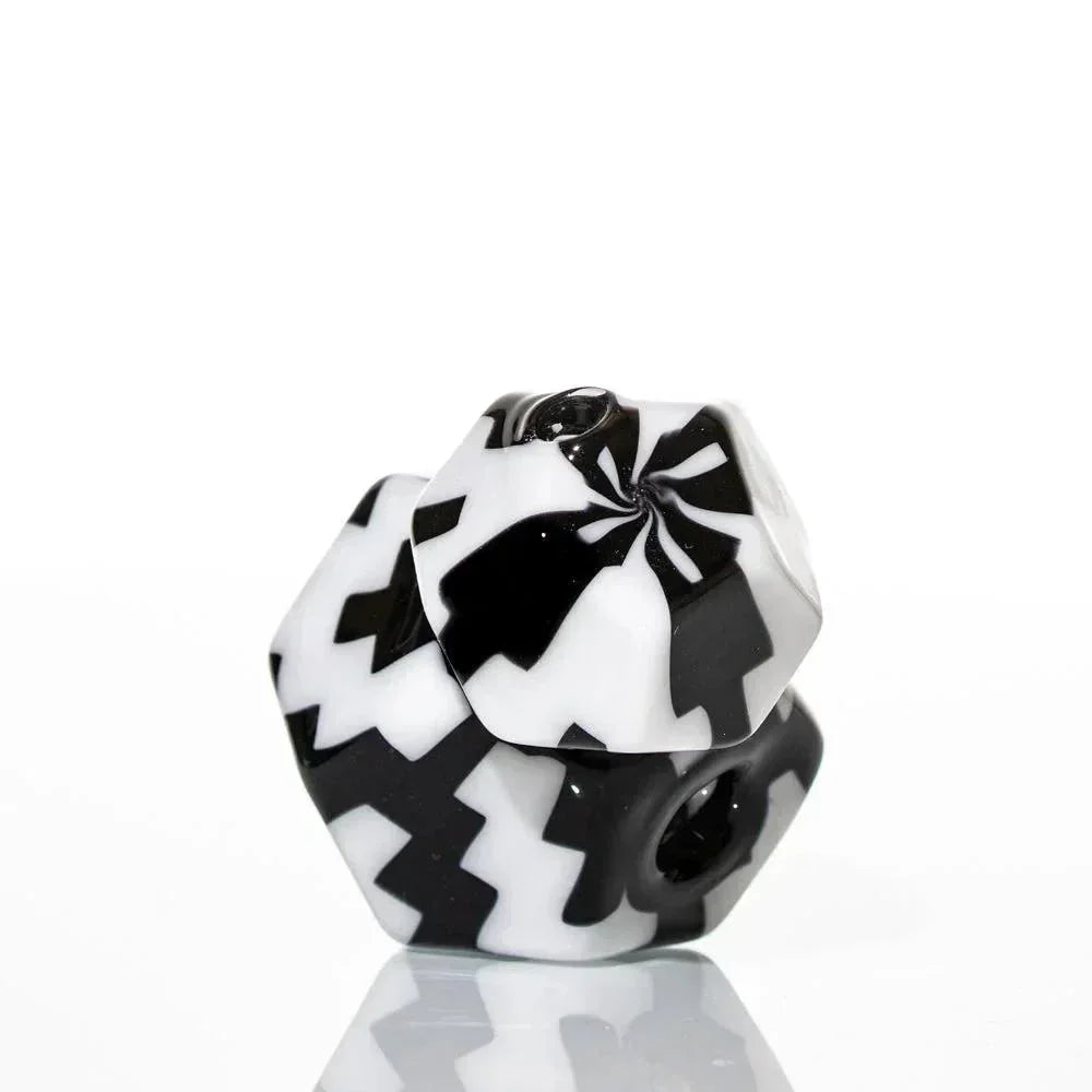 Black and white geometric glass smoking accessory with bold zigzag pattern on white background