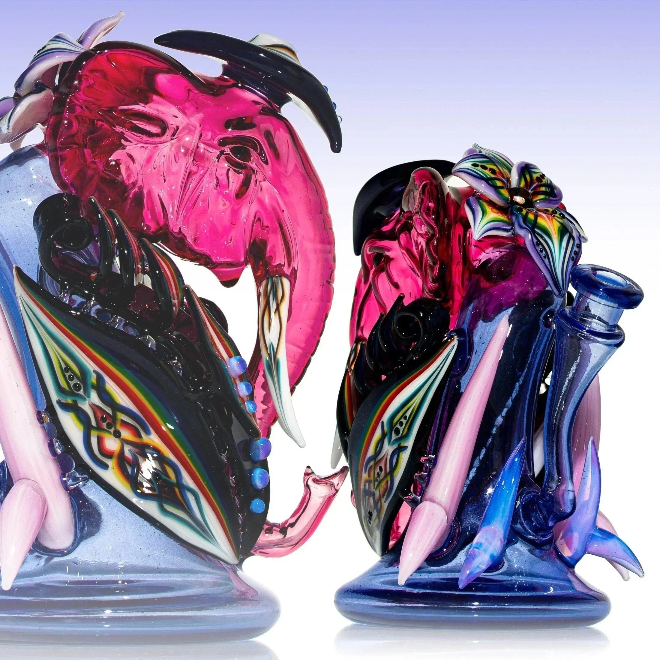 Colorful heady glass recycler rig with pink, purple, and intricate rainbow designs