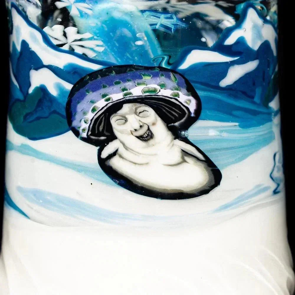 Detailed glass art featuring a whimsical mushroom figure with a snowy mountain background.