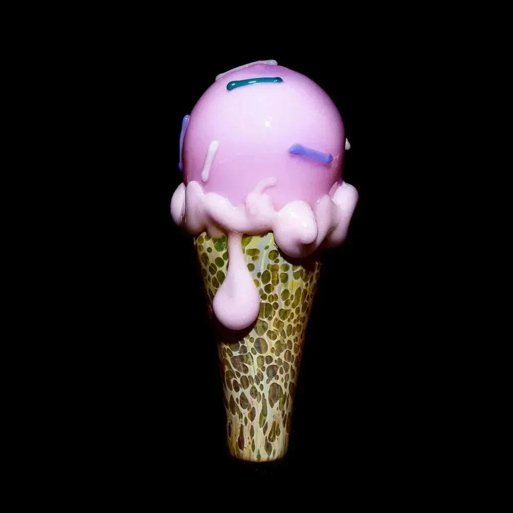 Glass ice cream cone pipe with pink scoop, drip details, and sprinkle accents on black background