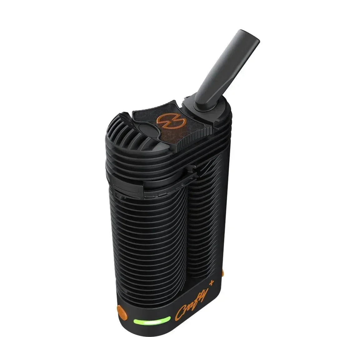 Portable black vaporizer with orange accents and mouthpiece, isolated on white background
