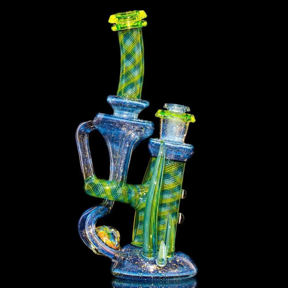Colorful heady glass water pipe with intricate green and blue designs, displayed on black background