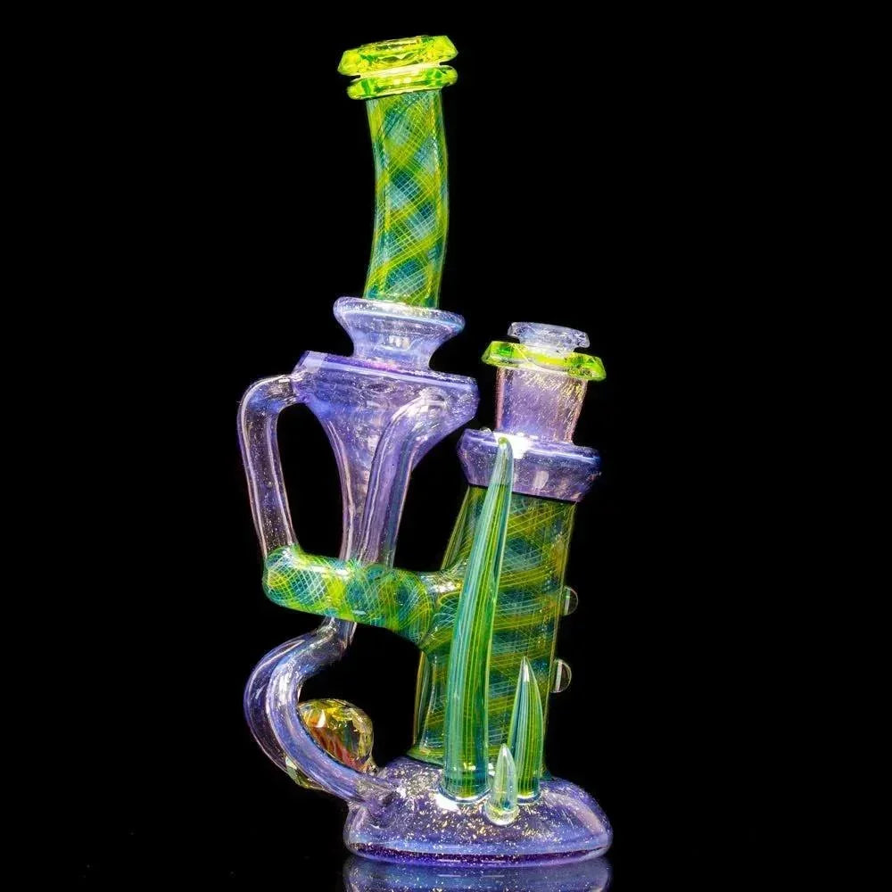 Colorful heady glass water pipe with intricate green and purple designs on black background