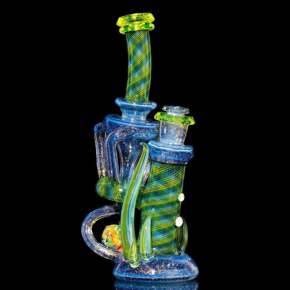 Colorful glass recycler water pipe with green and blue twisted accents on a black background