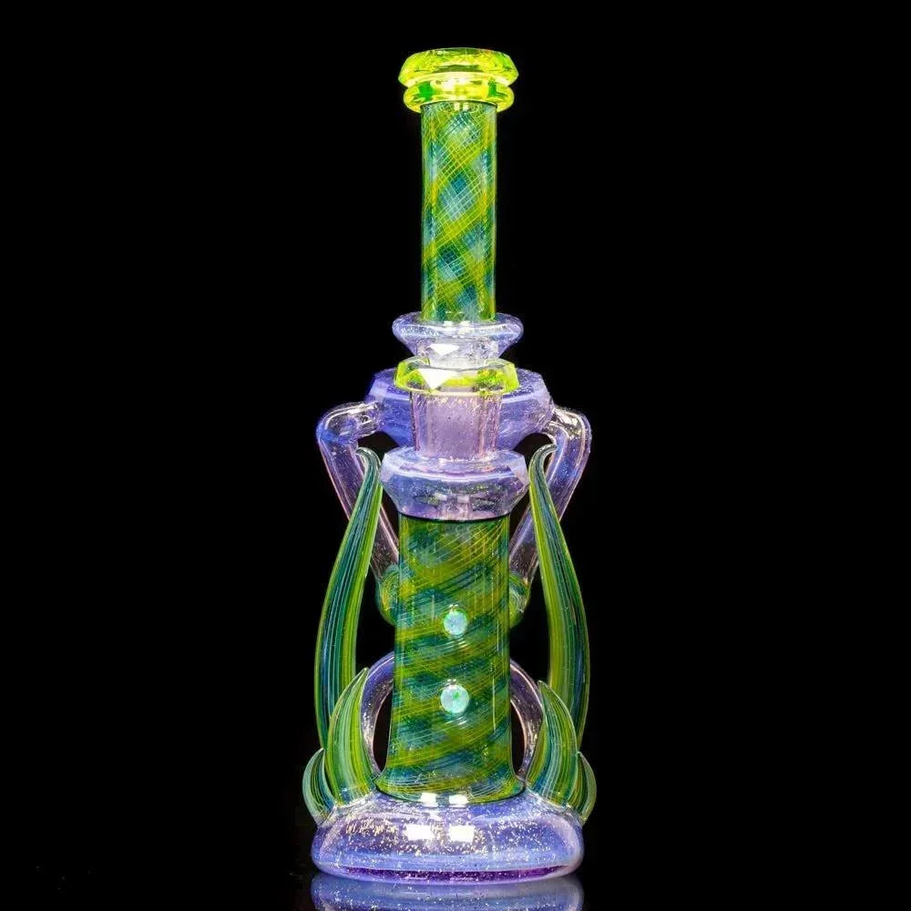 Colorful dichroic glass water pipe with green and blue swirling patterns on black background
