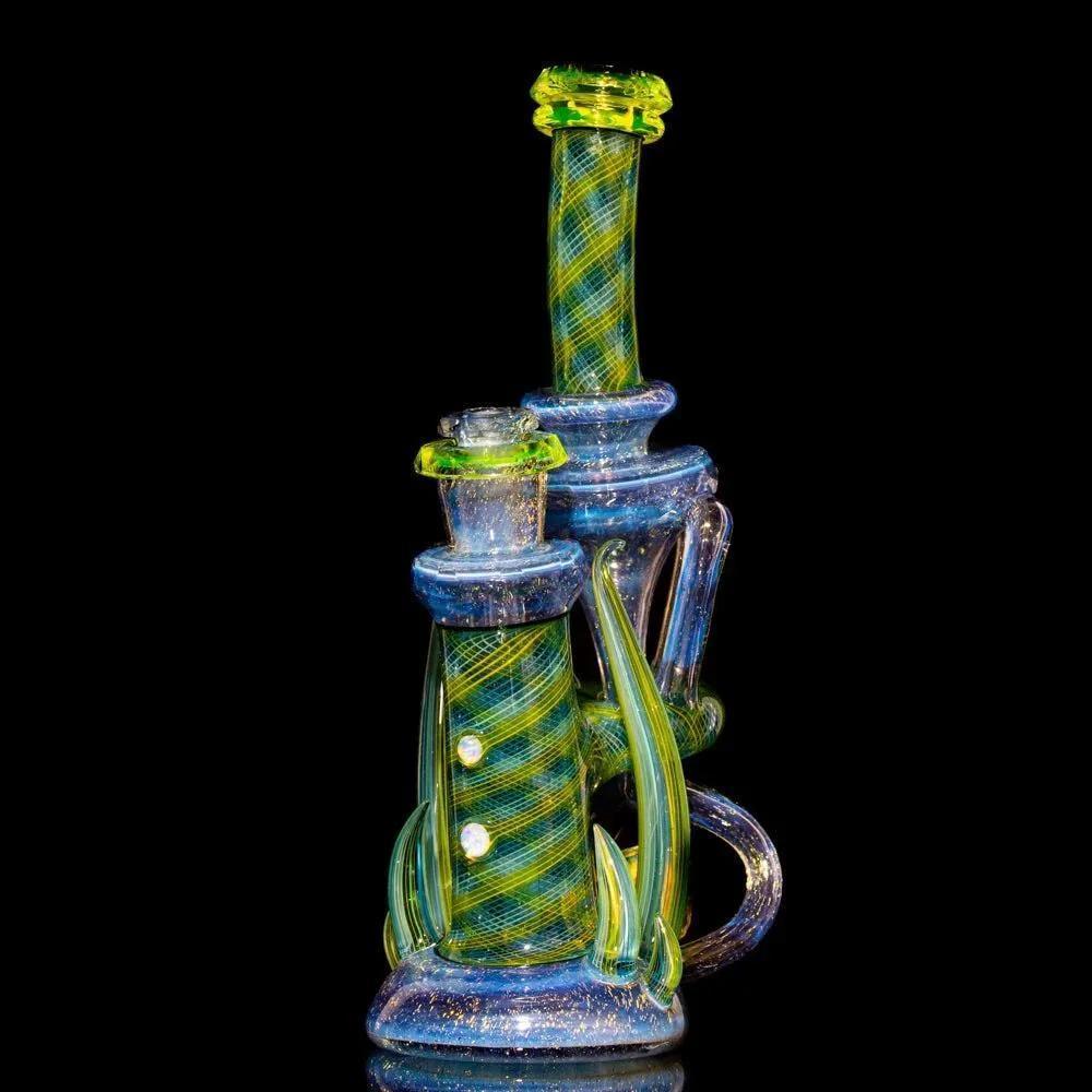 Colorful heady glass recycler rig with green and blue swirls on a black background