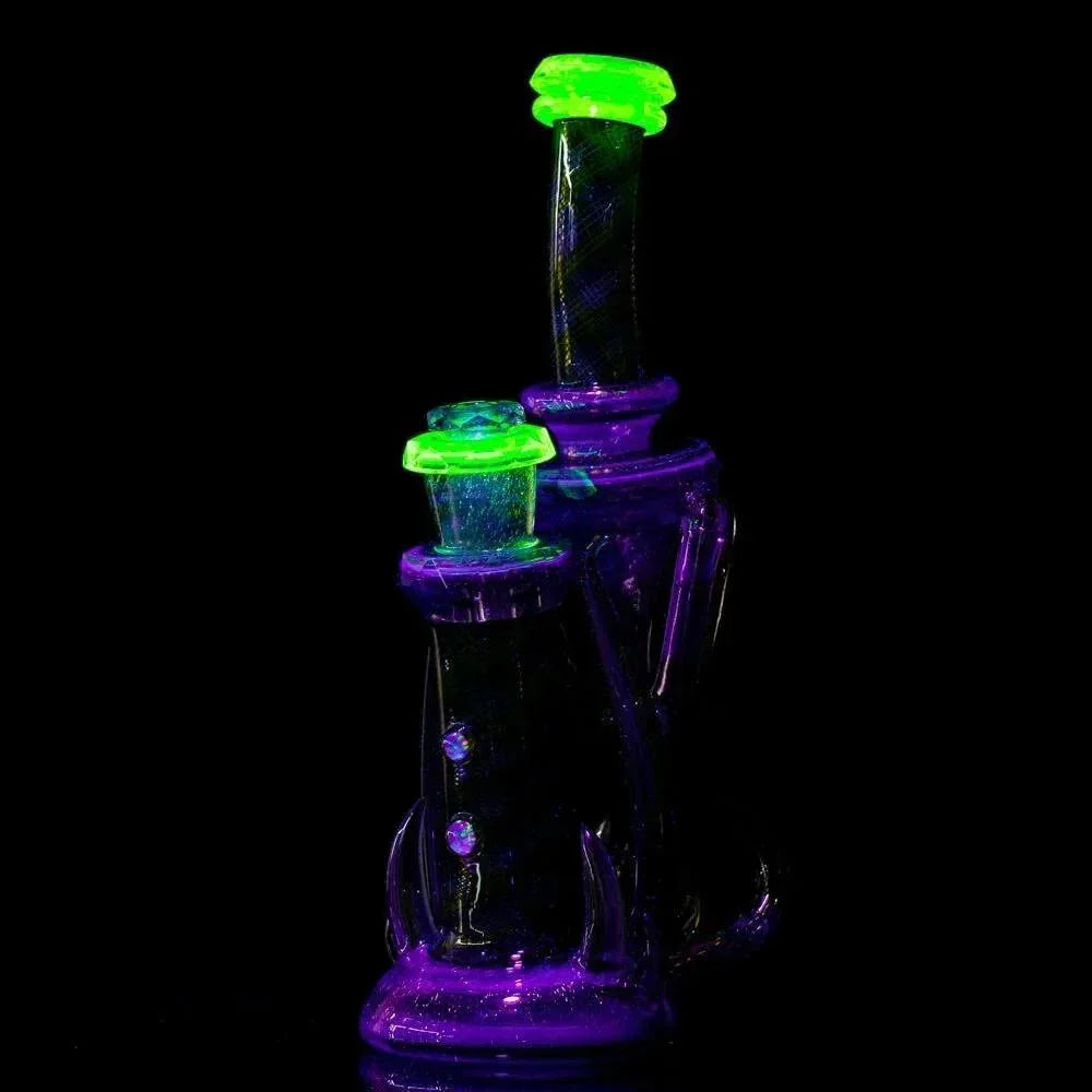Purple and neon green dichroic glass water pipe with glowing accents on black background