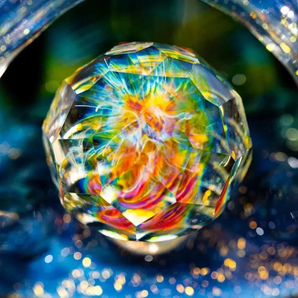 Close-up of a faceted dichroic glass marble with vibrant rainbow colors and intricate patterns