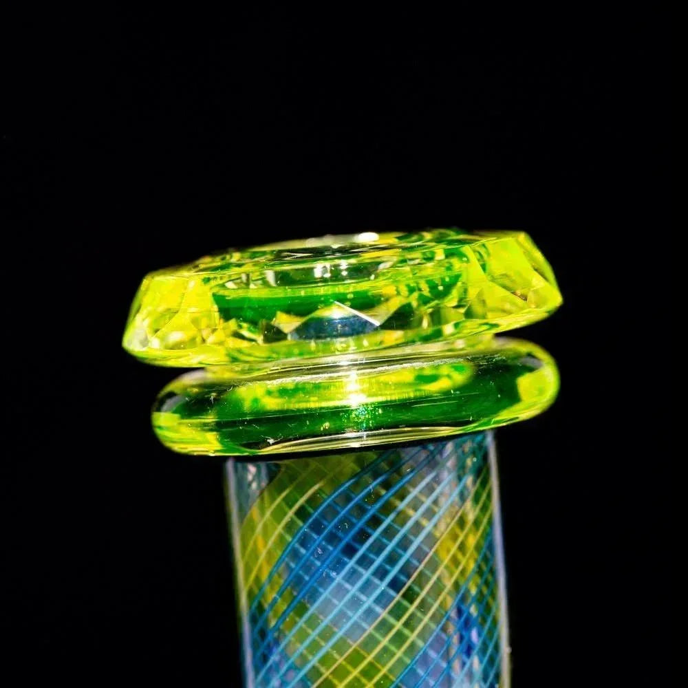 Close-up of a colorful dichroic glass water pipe neck with green and yellow accents