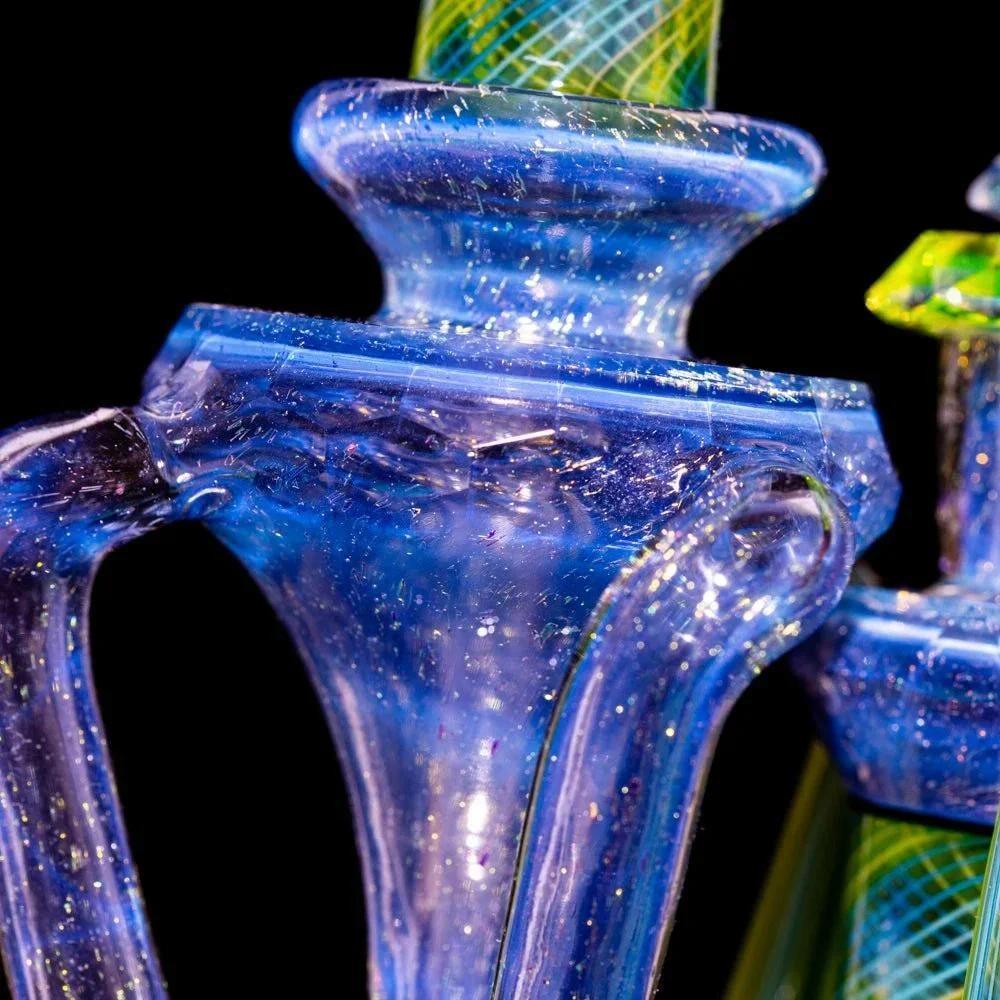 Close-up of iridescent dichroic glass water pipe with glittery blue and green accents