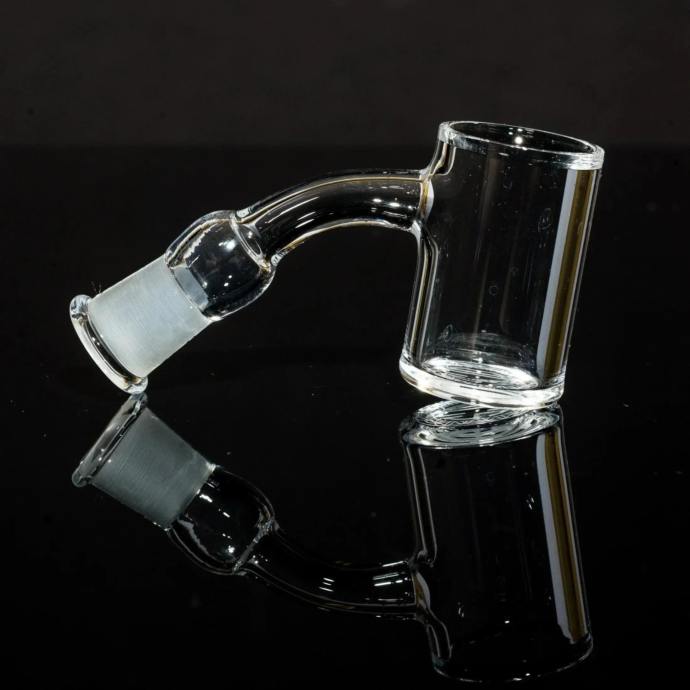Clear glass bong slide with curved neck and frosted joint, displayed on black reflective surface