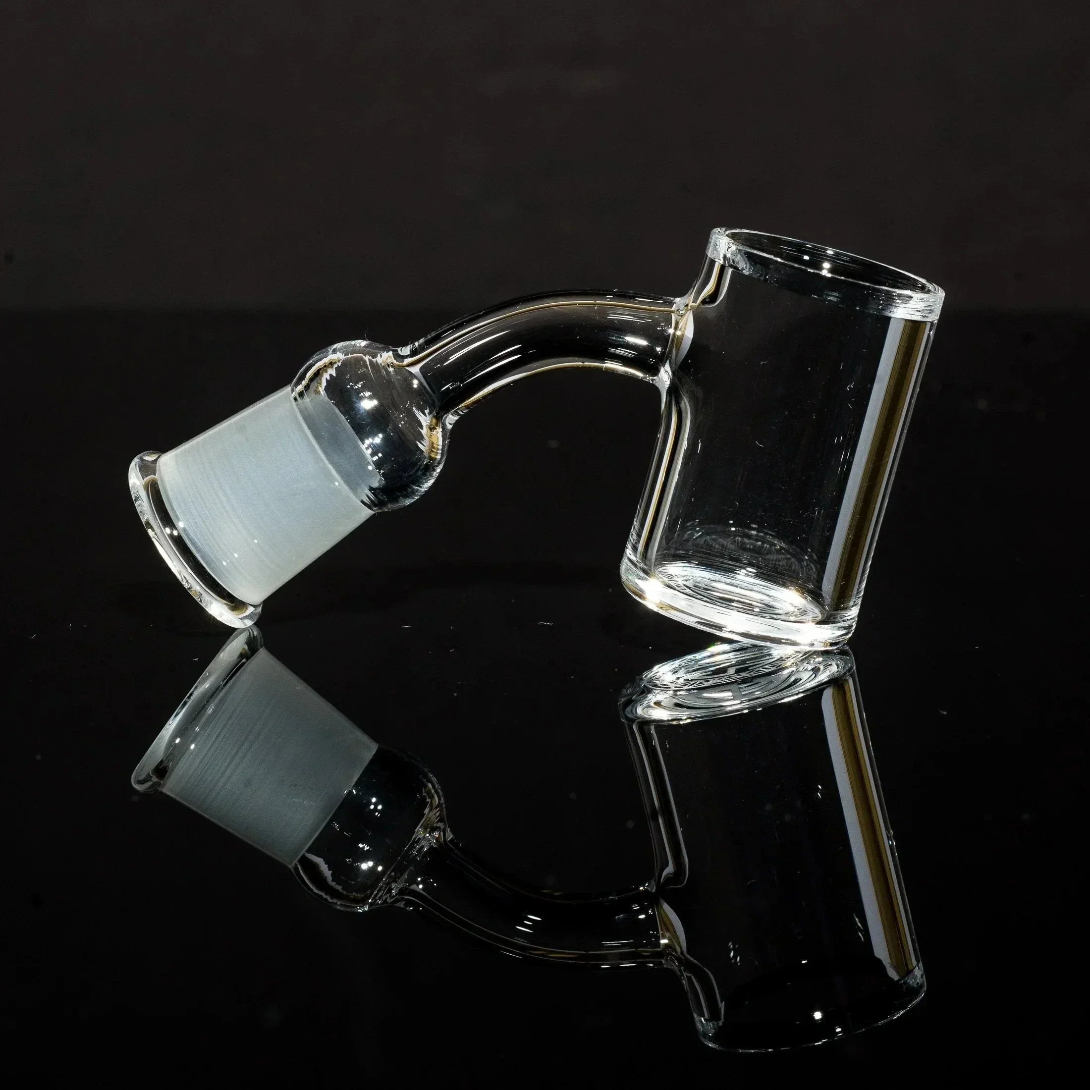 Clear glass bong bowl with frosted joint, sleek design on black reflective surface
