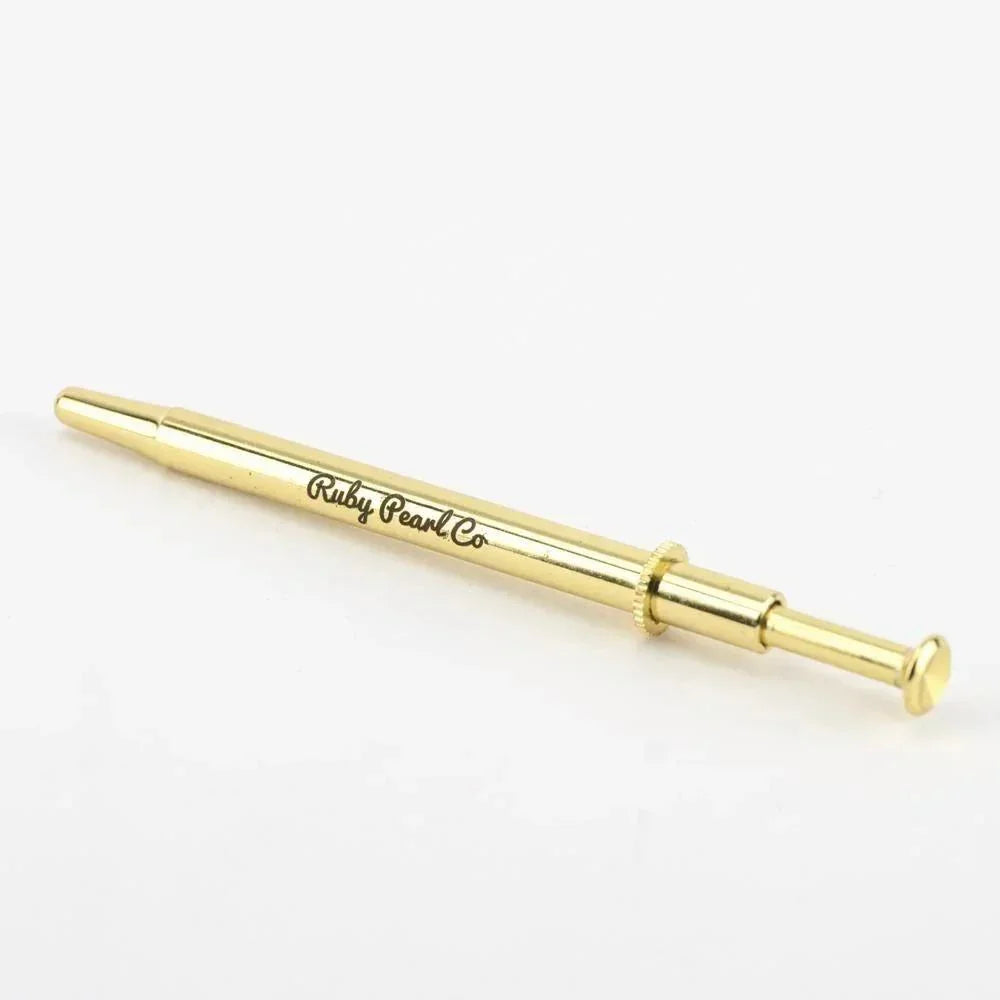 Gold metal dab tool with Ruby Pearl Co logo on white background