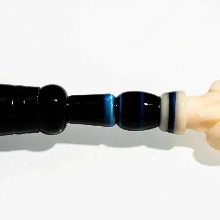 Black and blue glass pipe with white accents, heady glass design